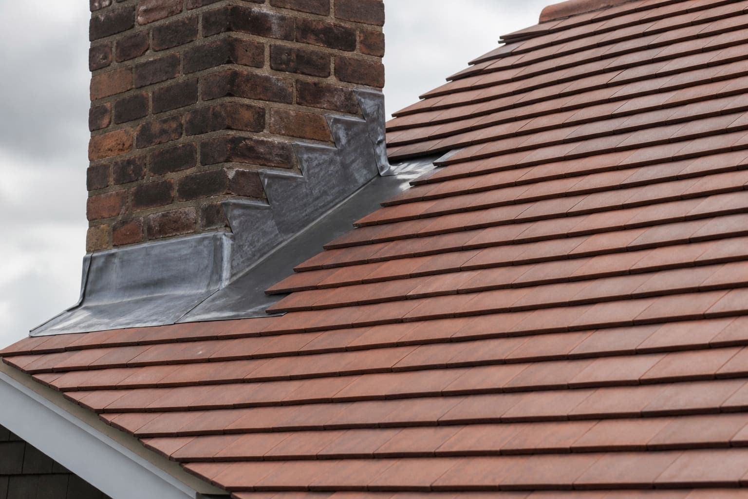 Example photograph of a clay tiled pitched roof on a brick house